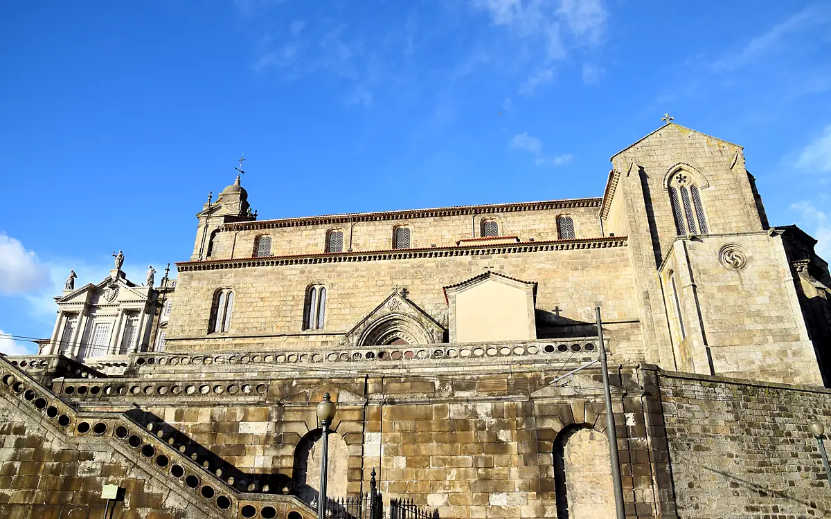 De lange zijgevel van de Igreja de São Francisco in Porto met steunberen, boven een hoge granieten kademuur